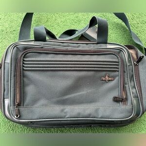 Dark green travel bag that can be used as a carry-on.